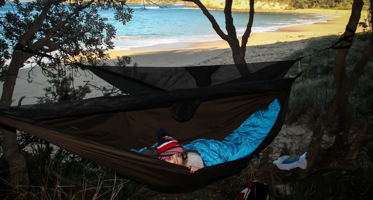 Top 6 Sydney Camping Escapes (by Public Transport), Henry Brydon, Royal National Park, hammock, woman, trees, beach, camping, sleeping bag, maitland bay
