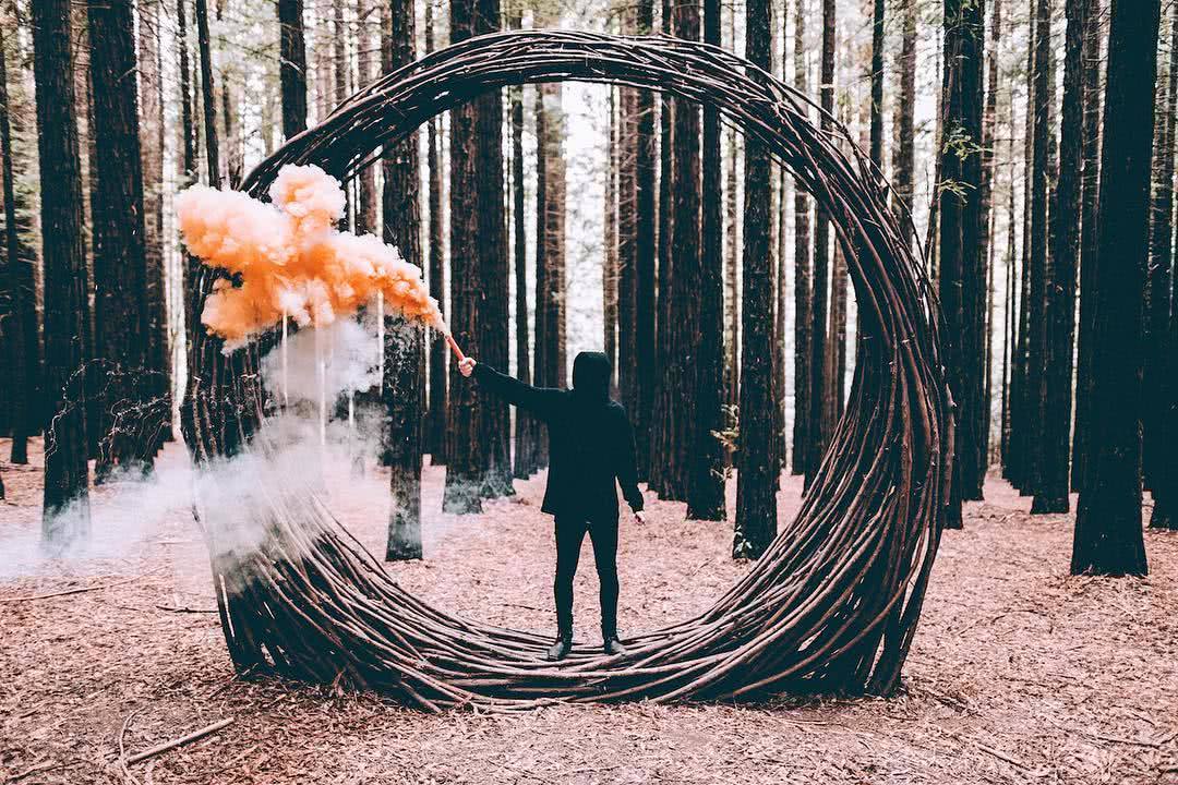 A person standing next to a fence