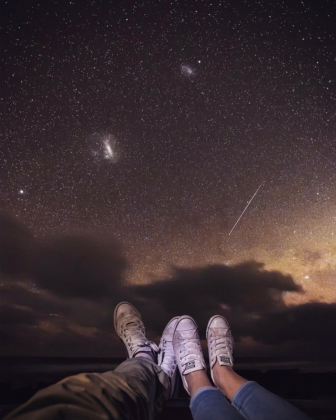 A man sitting in a dark sky
