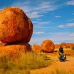 Essential Gear for Bikepacking Adventures, Henry Brydon,bike, person, red rock, blue sky, grass, outback