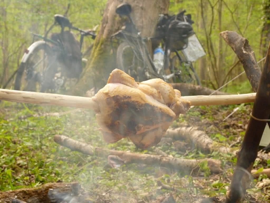 Essential Gear for Bikepacking Adventures, Henry Brydon,bikes, roast chicken on a spit, campfire, trees