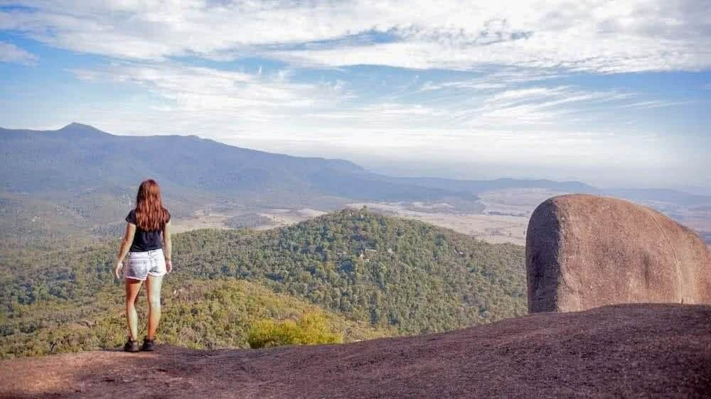 A man standing in front of a mountain