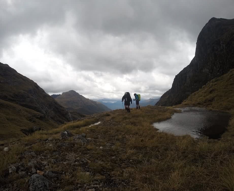The Hardest Hike in New Zealand // Dusky Track, Tim Ashelford, photo by mitch stewart, hikers, wet, mountains, cloudy,