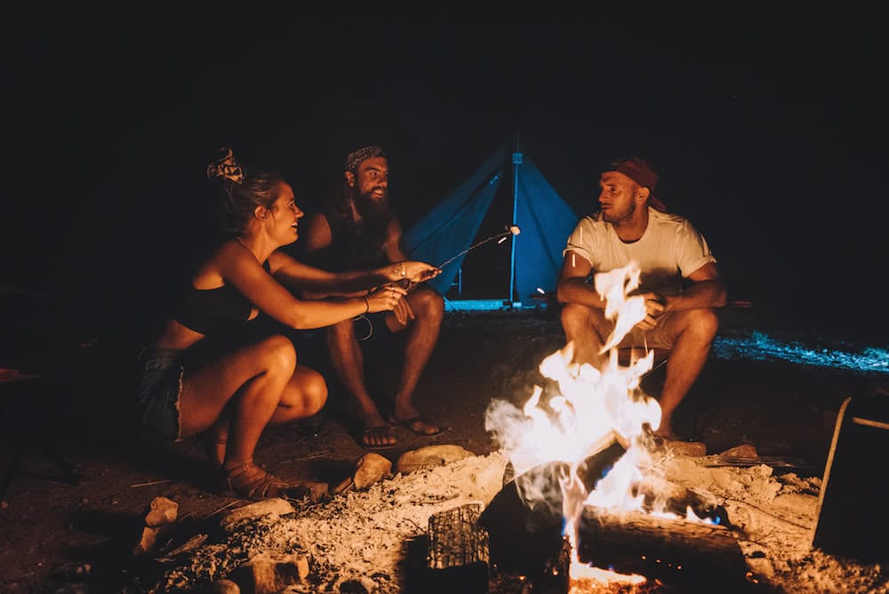 The Ultimate Road Trip Through the Red Centre Way, photo by laura bell, Glen Helen, people, campfire, camping, tent, laugh