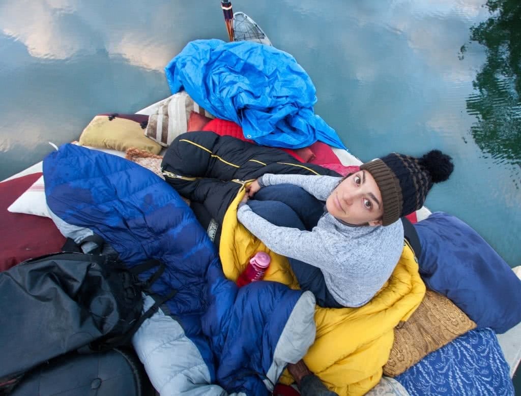 Travels By Tide // A Modern Day Huck Finn Adventure Joel Johnsson, raft, sleeping bag, woman, hat
