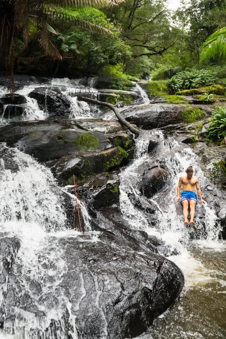 8 Ridiculously Beautiful Victorian Waterfalls To Chase This Summer Pat Corden Triplet Falls, slide, waterfall, cascade, swimmer, man, rocks, hero