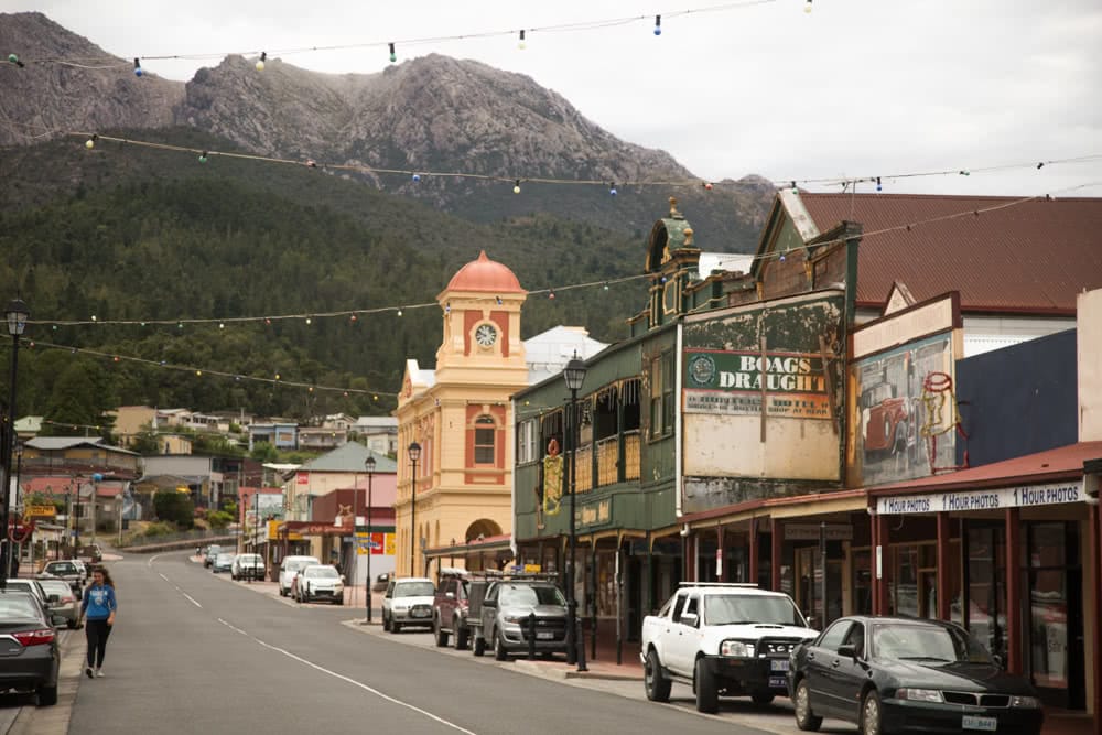 12 Things To Do On Tassie’s West Coast, photo by Nick Green, Queenstown Tasmania, mountains, town, street, cars, light, shops 