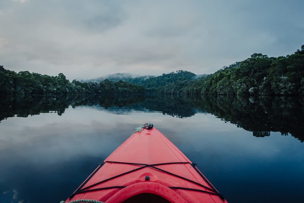 12 Things To Do On Tassie’s West Coast, photo by Henry Brydon, kayak, river, forest, cloud, reflection, Corrina Kayaking
