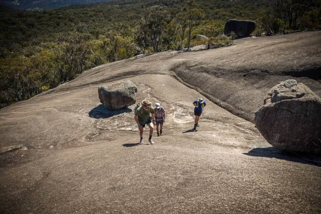 Picnics And Secret Passageways // Mt Norman (QLD), Lisa Owen, WAE_MtNorman_Slabascent, smooth rock, hikers, climbing, gully, erosion