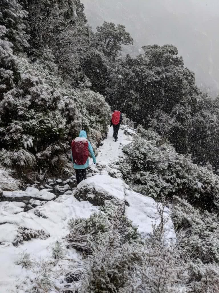 Soggy, Snowbound And Stoked // Routeburn Track (NZ), Rachel Dimond, Day 3 - The snow storm, hikers, trail, mountainside