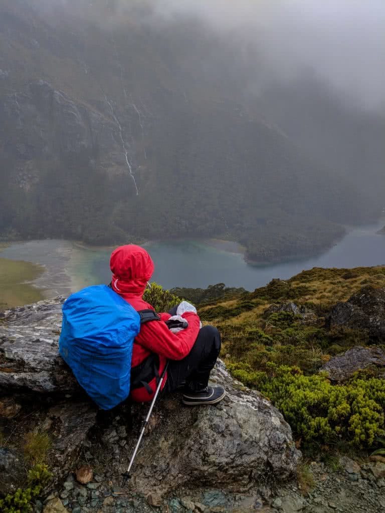 Soggy, Snowbound And Stoked // Routeburn Track (NZ), Rachel Dimond, Day 2 - Lake Mackenzie from the Hollyford face, waterproofs, rain cover, backpack, river, valley lookout, view