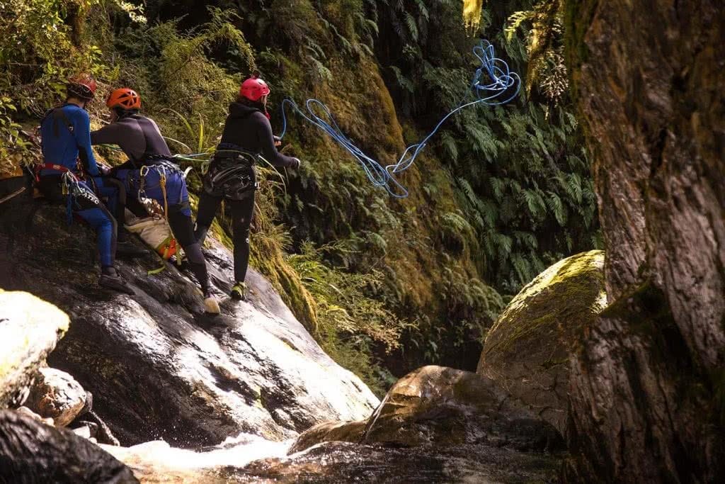 Ode To The River // Canyoning And Packrafting In New Zealand, Xavier Anderson, throwing rope, boulders, rocks, helmets