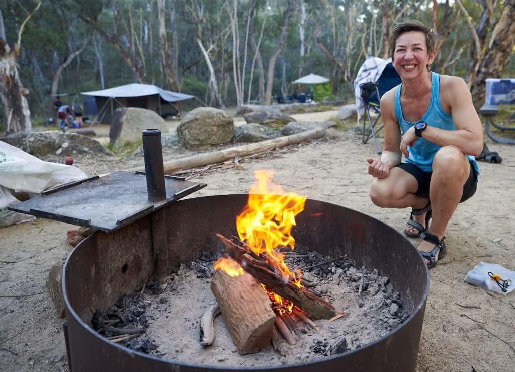 How To Make An Awesome Campfire Without Matches, photo by Neil Massey, fire, wood, sticks, fire pit, woman, campsite