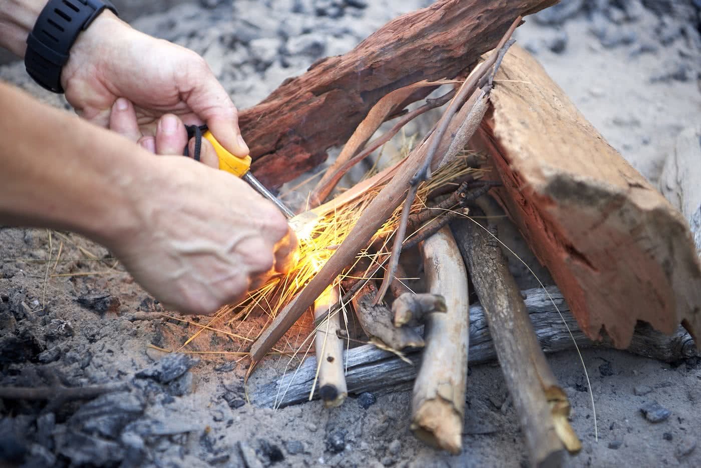How To Make An Awesome Campfire Without Matches, photo by Neil Massey, fire, wood, sticks, fire pit, hands
