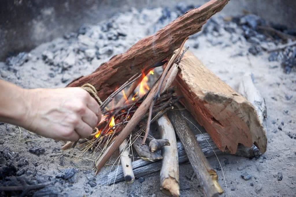 How To Make An Awesome Campfire Without Matches, photo by Neil Massey, fire, wood, sticks, fire pit, hands