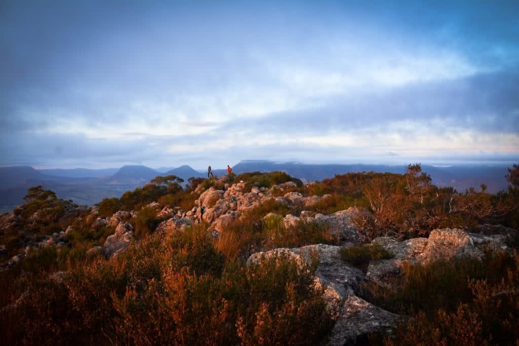 The 5 Best Sunrise Spots Near Brisbane, Lisa Owen, Hikes_Mt Maroon, people, orange, rocks, dawn light, cloudy, moody