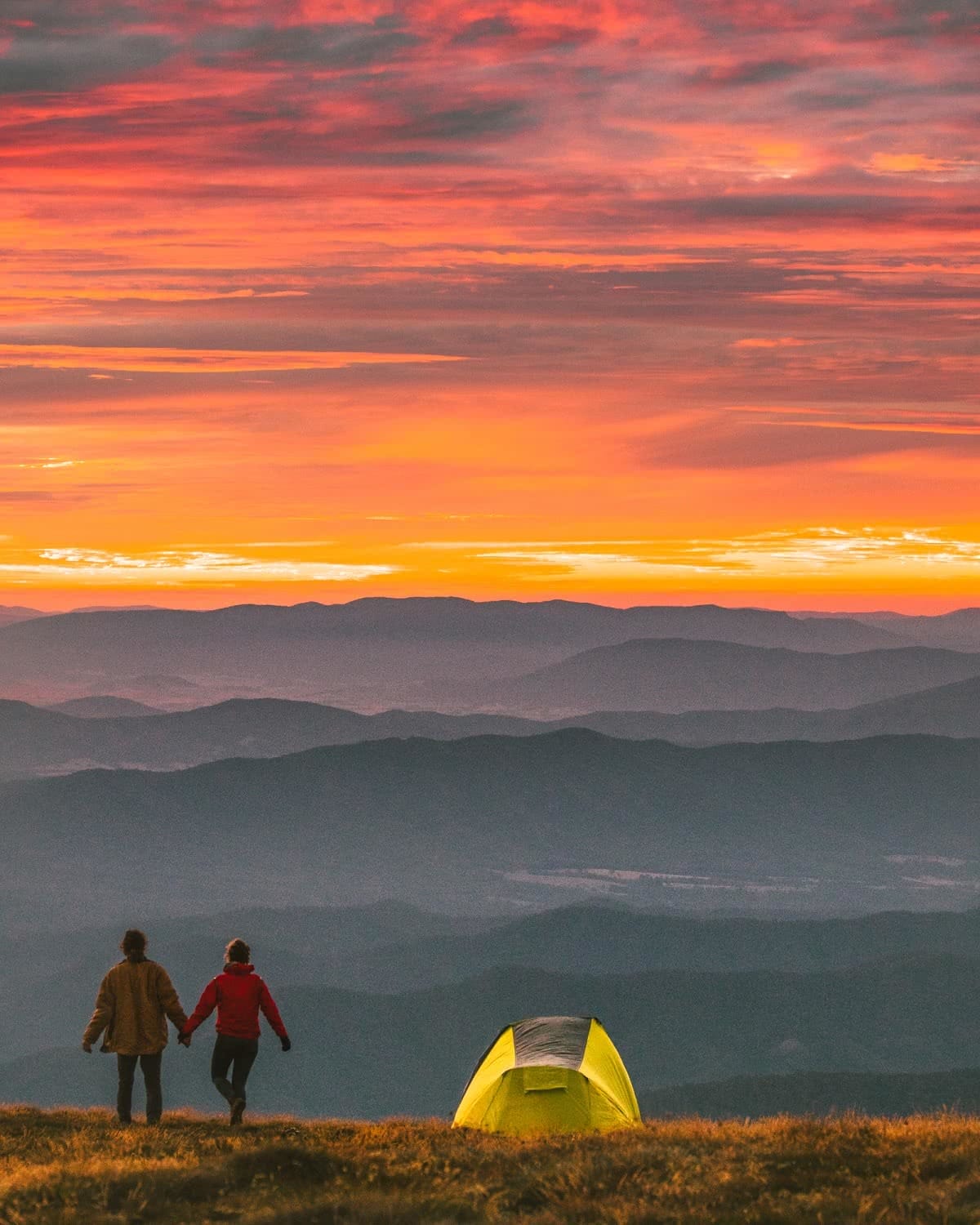 What We Learnt From 4 Years On The Road // Van Life Revisited, mitch cox, snowy mountains tent camping, tent, couple, holding hands, sunset, clouds, distance