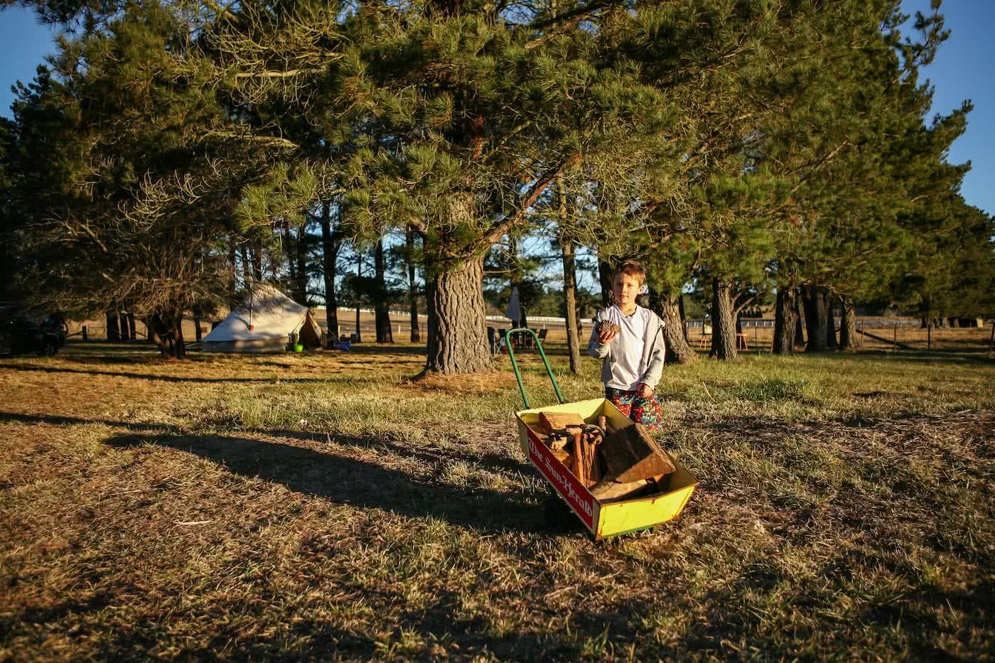 Two Wheels And A Teepee // Glamping & Cycling In Bowral (NSW), Karl Reynolds, wheelbarrow, firewood, trees, camping, bell tent, kid