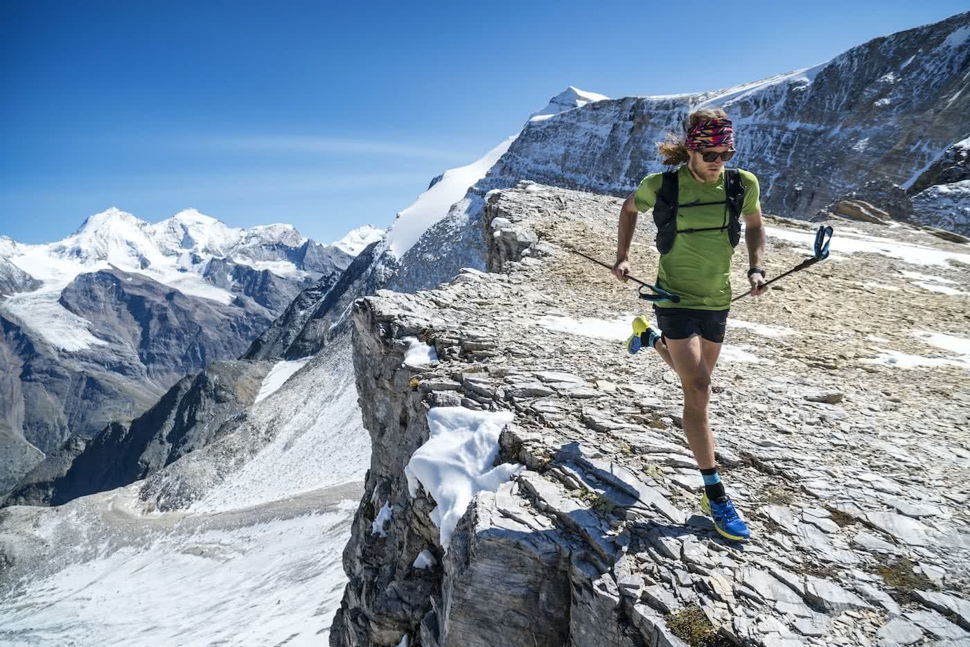Runner Guy // An Interview With Trail Runner Joe Grant, Photo by Dan Patitucci, running poles, cliff edge, mountain, snow