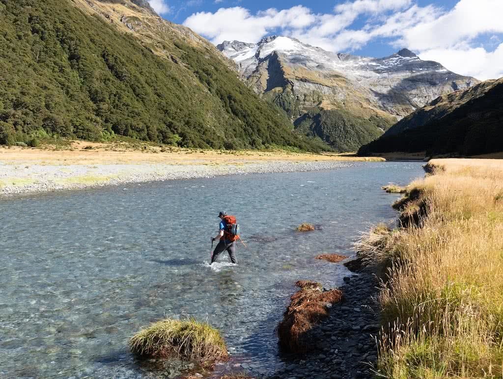 Gillespie Pass Circuit – the Best NZ Multi-day Hike You’ve Never Heard Of Aidan Howes, photo by Sonja Saxe hiker, backpack, river crossing,