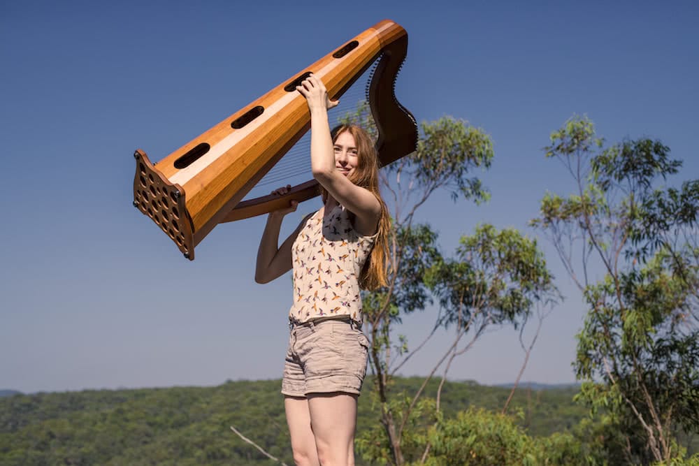 This Couple Is Thru-Hiking Between Concerts Across NZ, Mickey and Michelle, photo by Daniel Di Biase, harp, fiddle, blue mountains