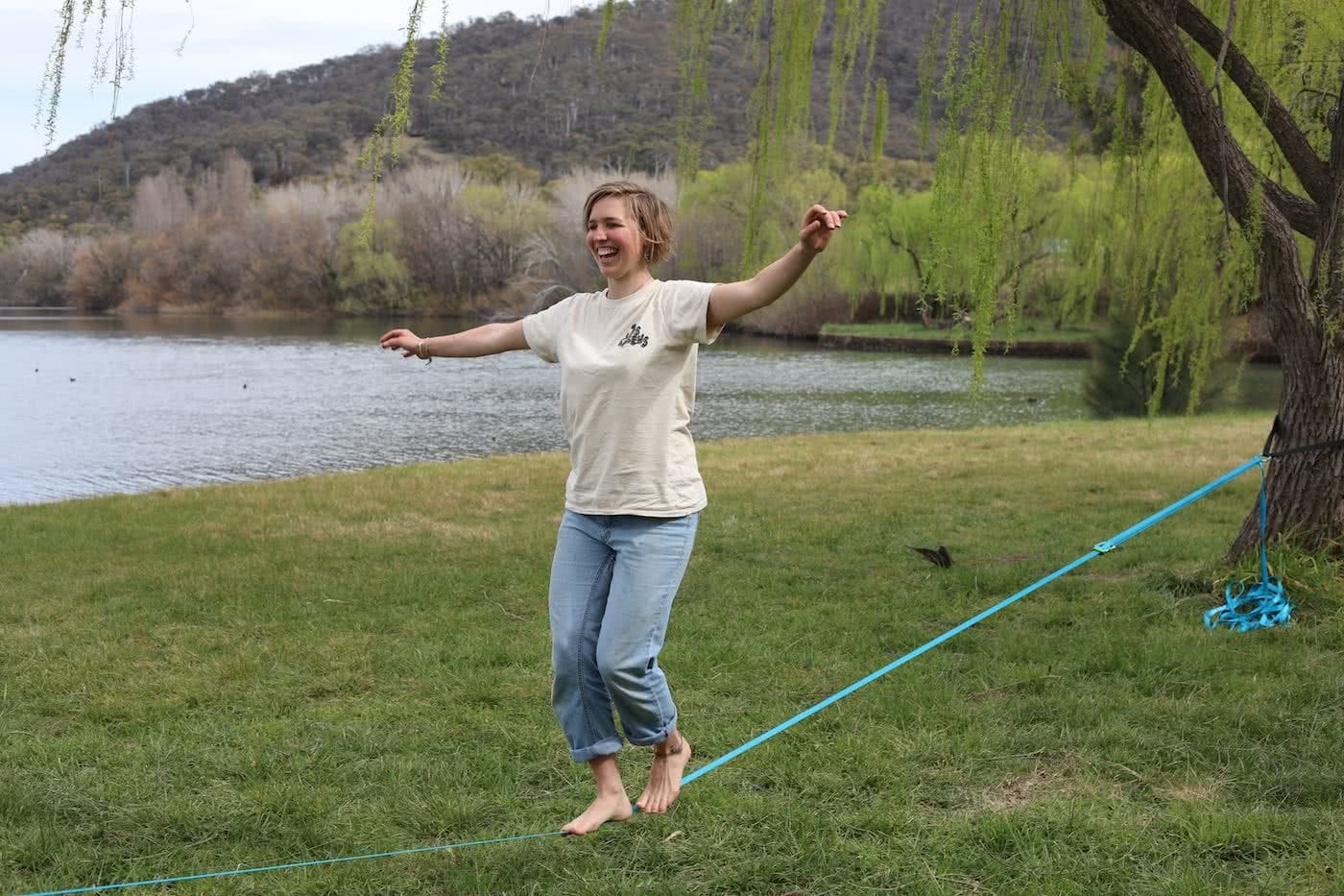 How To Squeeze More Outdoors Time Into Your Workday by Mattie Gould Smiling and slacklining in Canberra