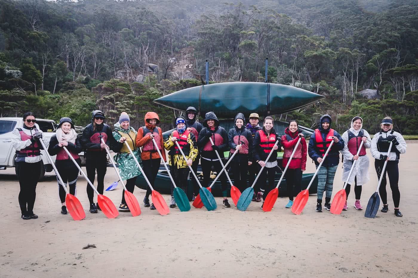 Why Do We Need Women Only Adventure Events?, photo by (), kayaks, paddles, group, women, rain, raincoats