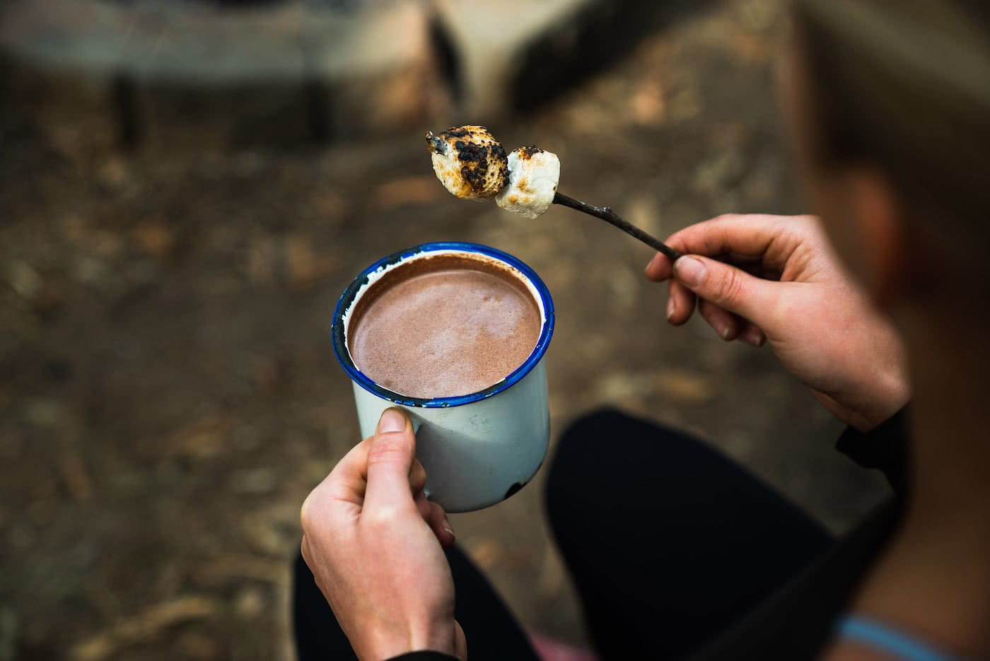 This Boozy Hot Choccy Is The Perfect Nightcap For Camping, photo Jonathan Tan, stick, marshmallows, hand, hot chocolate, woman