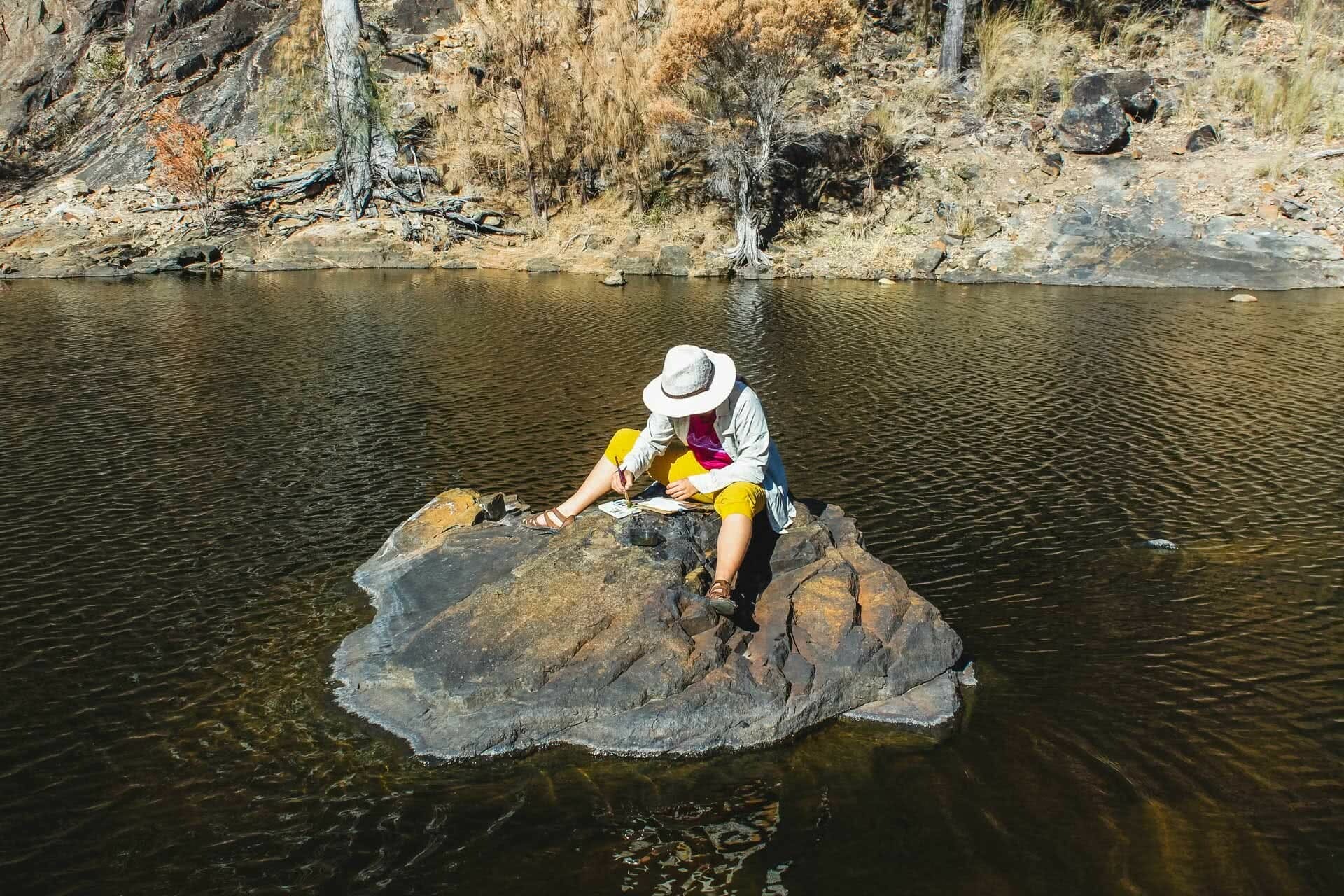 Sun-up to Sundown National Park – The Mt Donaldson Circuit (QLD), Saphira Schroers, photo by Mitchell Quinn, Painting at Wallaby Rocks, river, rocks, painting