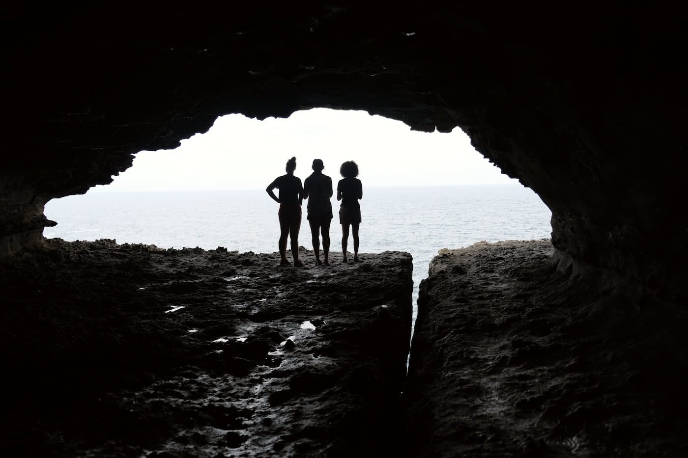 Scramble Through Gosang's Tunnel in Jervis Bay, Brooke Nolan, rocks, people, silhouette, ocean, cliffs