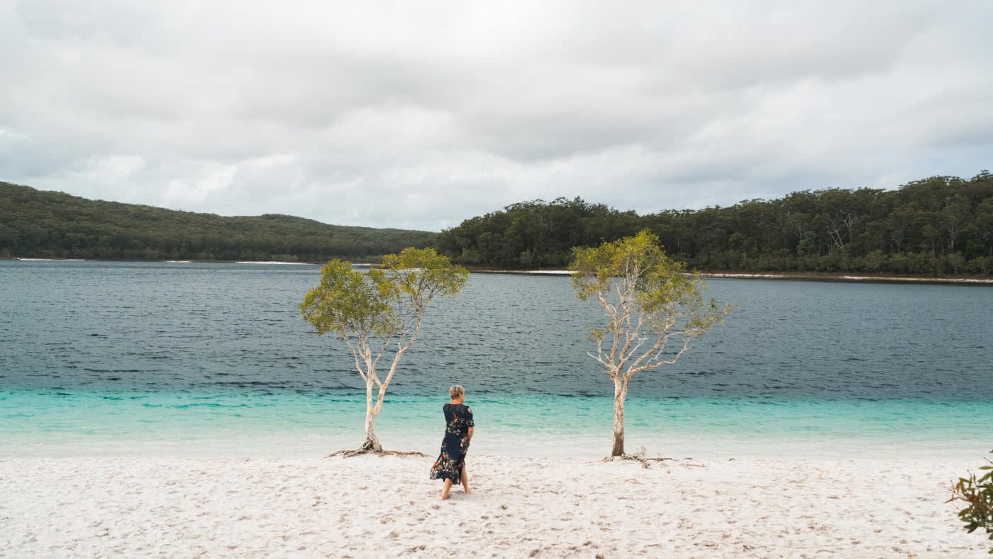 Fraser Island: Hiking To Lake McKenzie (No 4WD Required), Scott Pass, gumtrees, woman, lake, blue water, mountains