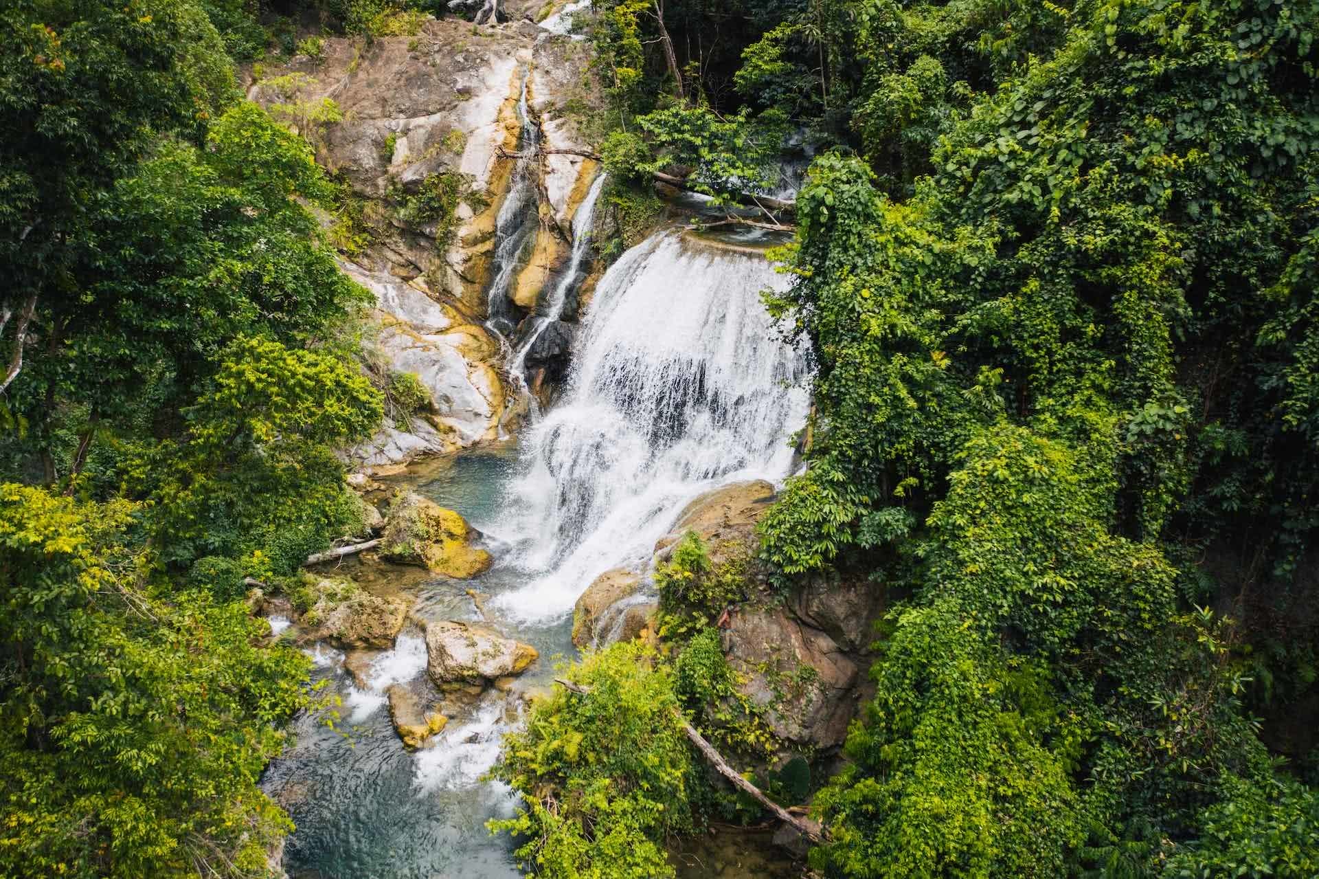 An Insider's Guide To Malekula Vanuatu , Ruby Claire, photos by Ain Raadik and Ben Savage, waterfall, jungle, rainforest, overhead shot, river