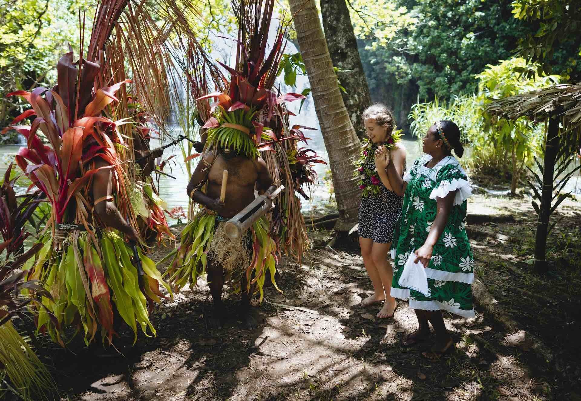 10 Things You Need To Know When Travelling Vanuatu's Outer Islands, Ruby Claire, photos by Ain Raadik and Ben Savage, custom dress, dancing, palm trees, women, Maewo - Naone falls arrival dance