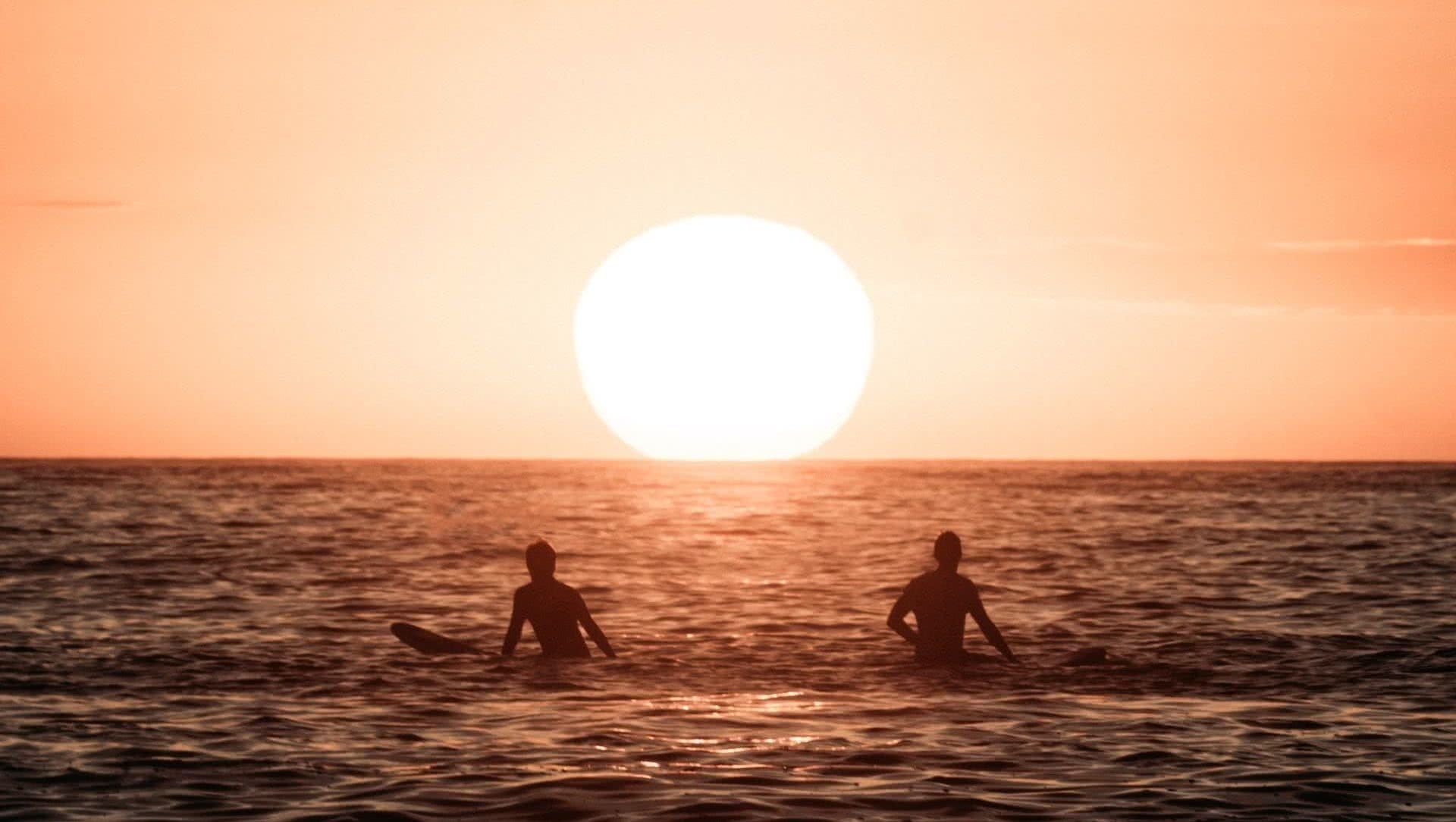 There's a Story Behind Every Photo: Adventure Photographer Fin Matson, photo by Fin Matson, Jono Tan, sunrise, beach, surfers, sun, ocean,