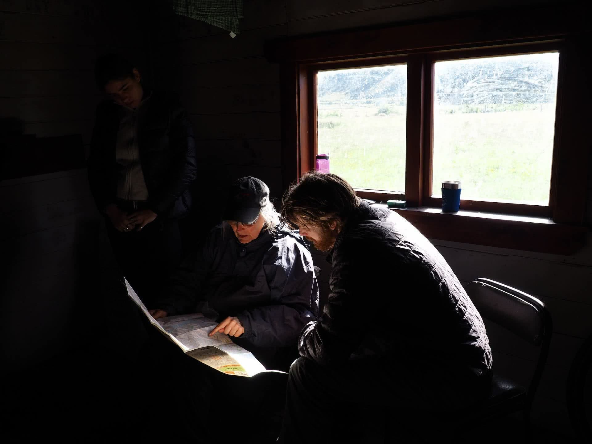 Bikepacking Somewhere over the Rainbow Trail (NZ), Ruby Woodruff, New Zealand, people, cabin, hut, map, navigate