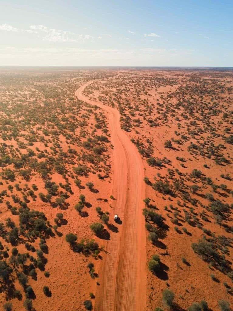 Lambert Centre of Australia – Down Under's Dead Centre (NT), Conor Moore, desert, red sand, drone shot, scrub, car, 4WD, troopy, dirt road, outback