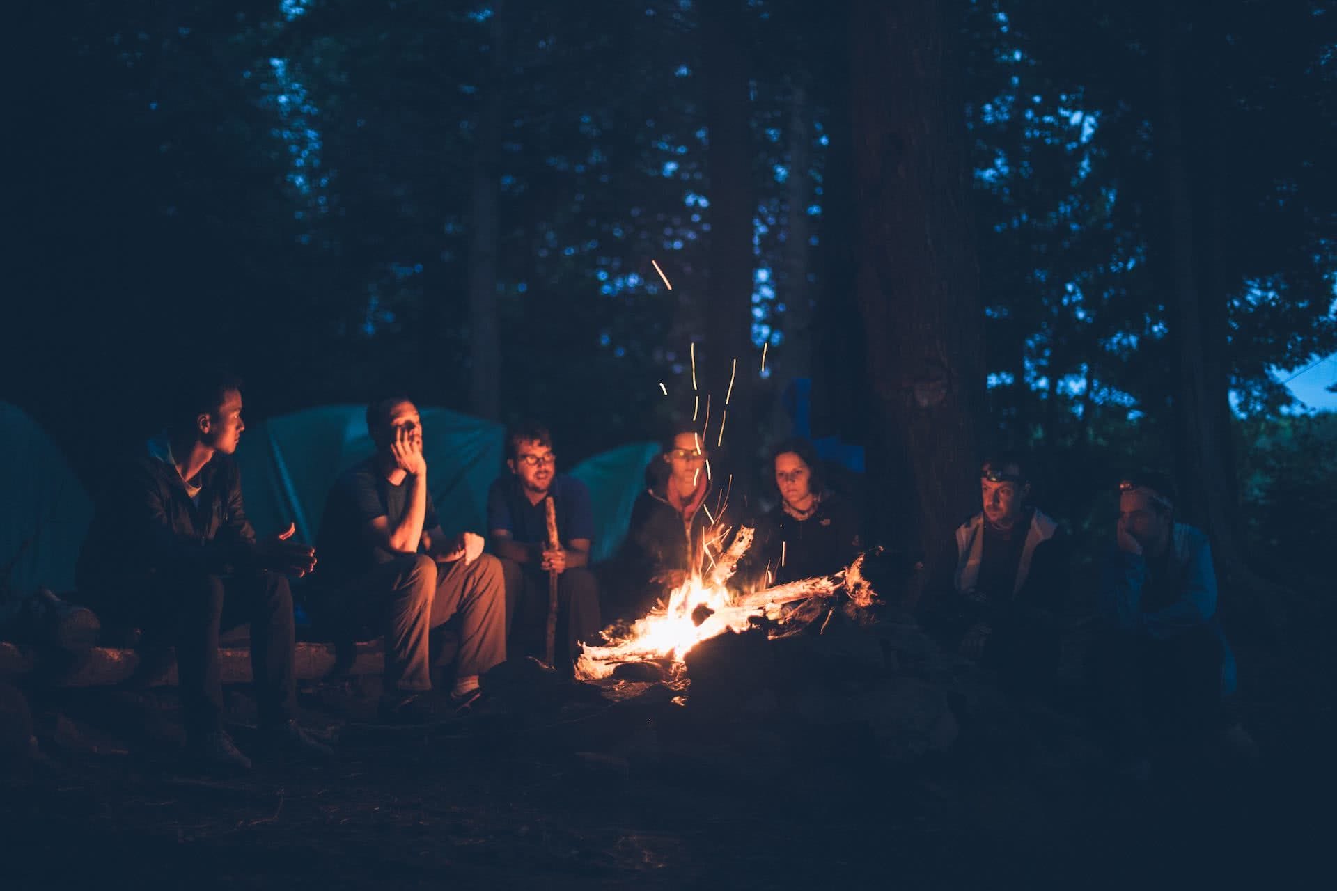 A group of people standing around a fire