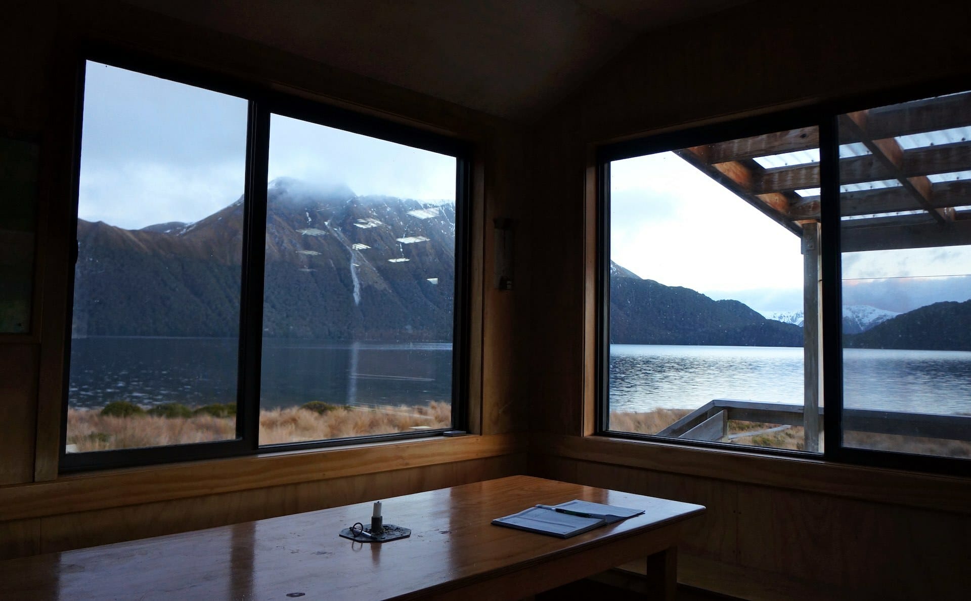 Green Lake Hut is a Secret Winter Escape in NZ's Fiordland, Arden Haar, hut, mountains, lake, windows