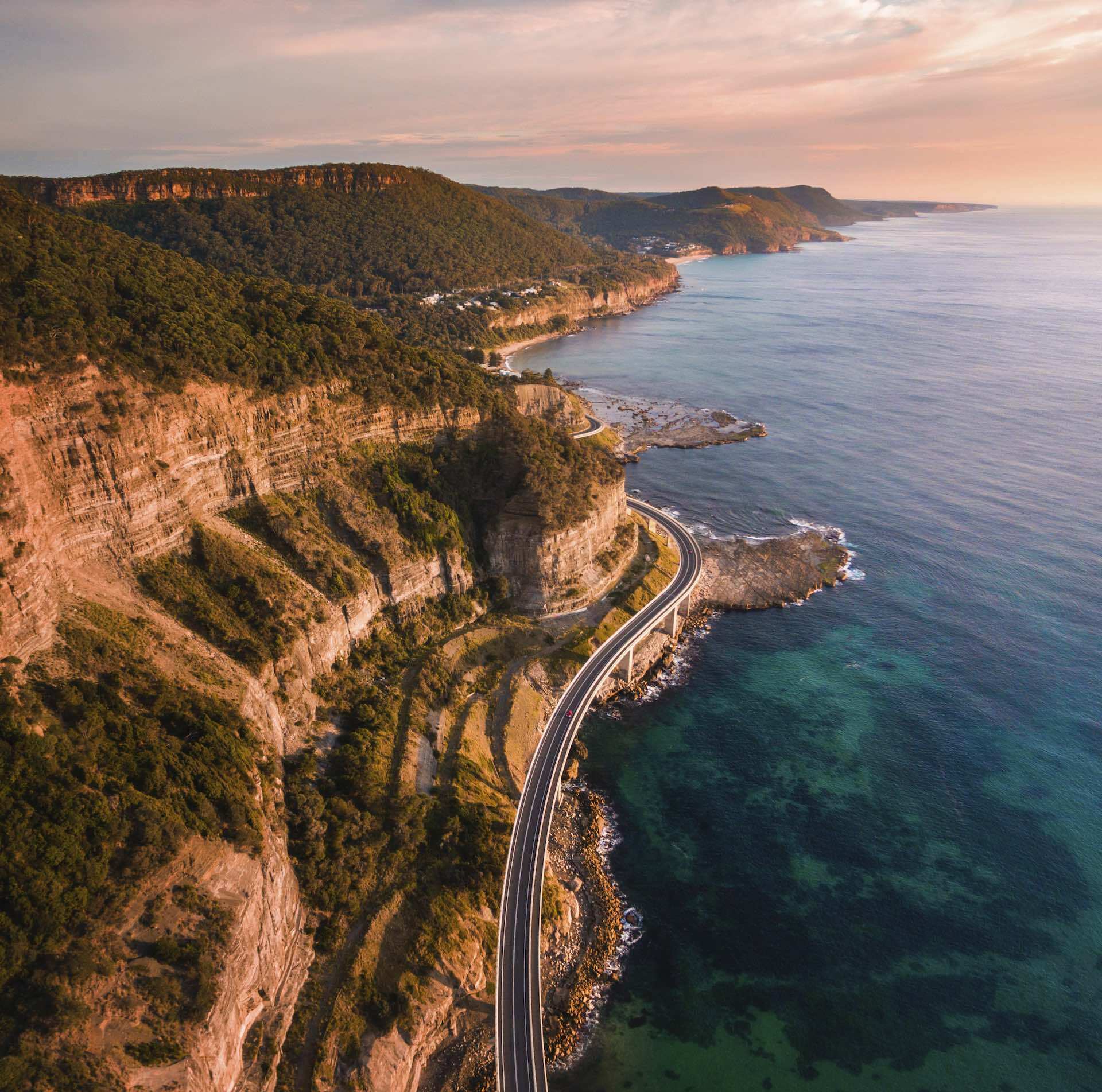 Three Action-Packed NSW Road Trips for People Who Seize the Day, photo provided by DNSW, Sea Cliff Bridge, Clifton, drone shot, ocean