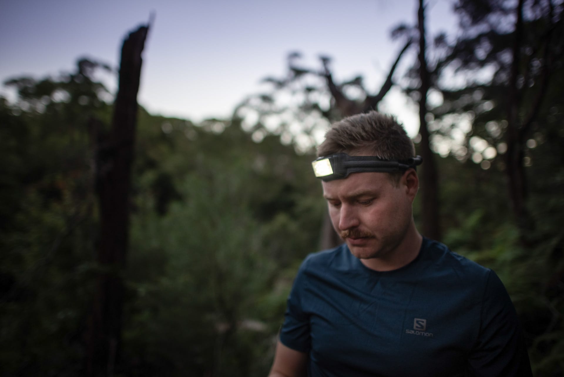 A man standing next to a tree