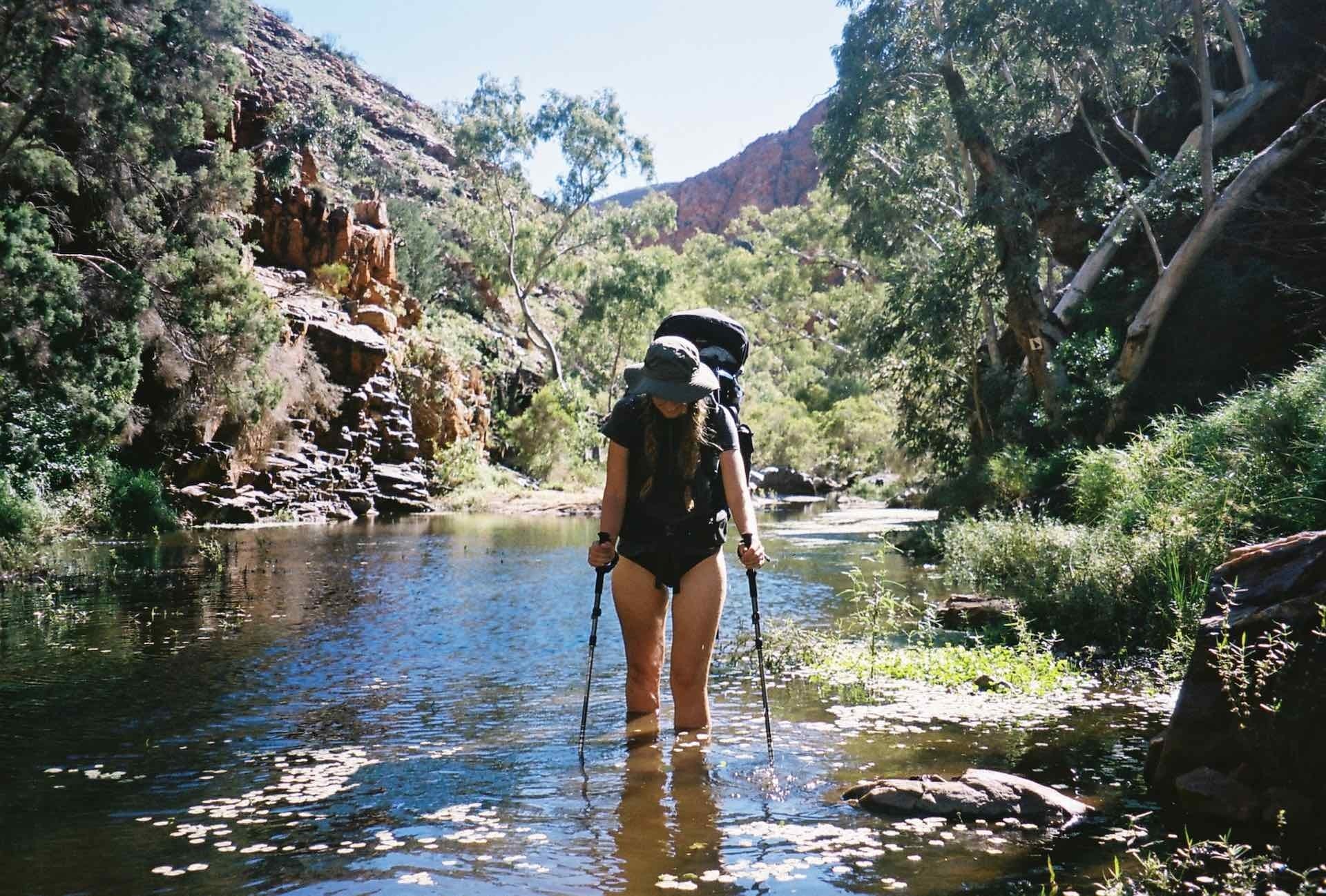 10 Things You Need to Know Before Hiking The Larapinta Trail, Ruby Claire, Central Australia, gorge, river, woman, hike, wade, hiking poles