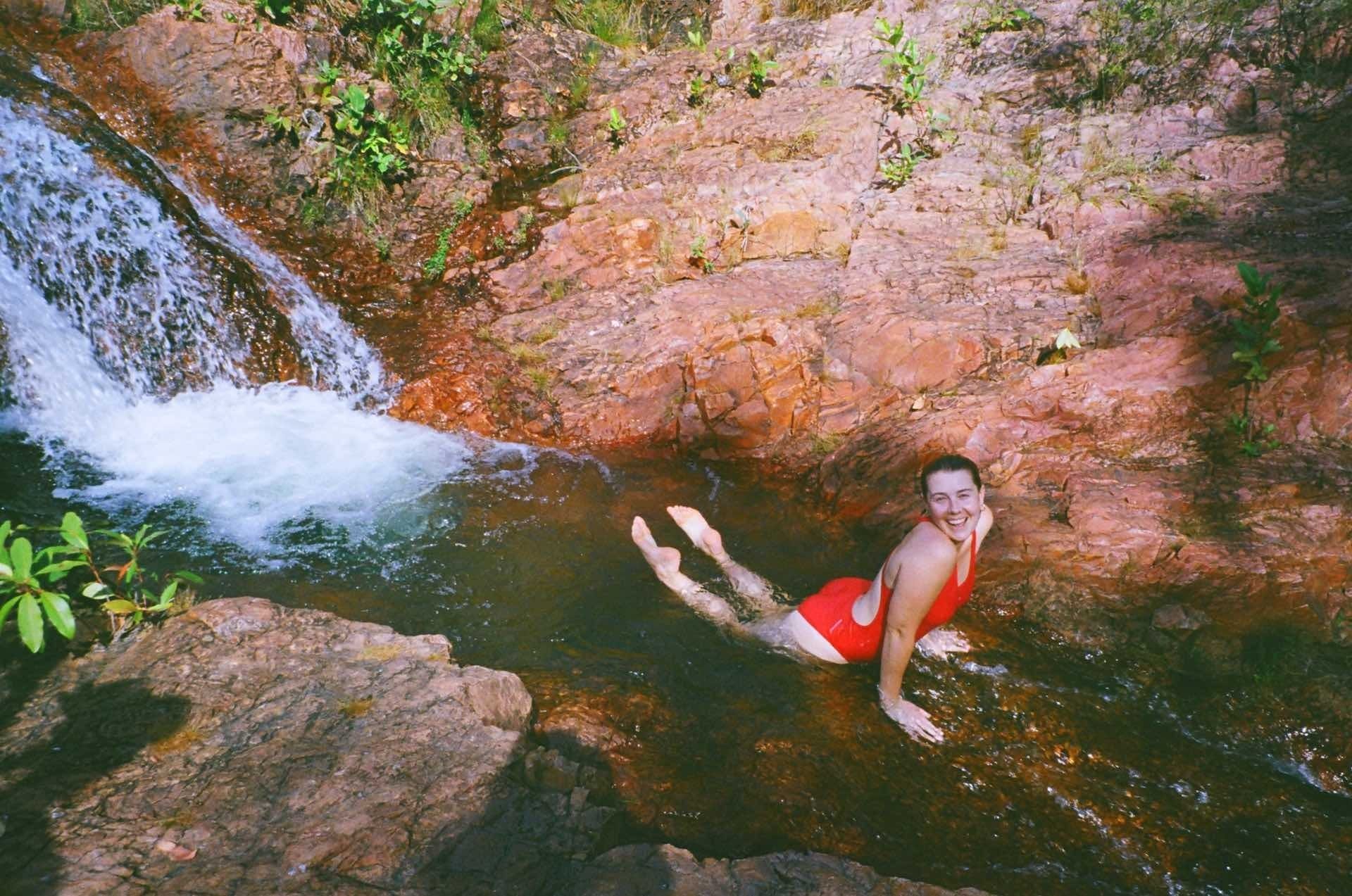 Road Tripping Through Litchfield National Park, Amy Fairall, Walker Creek, waterfall, woman, happy, smile, swimming hole