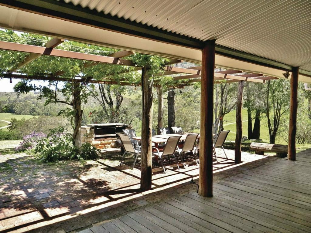 A wooden bench in front of a building