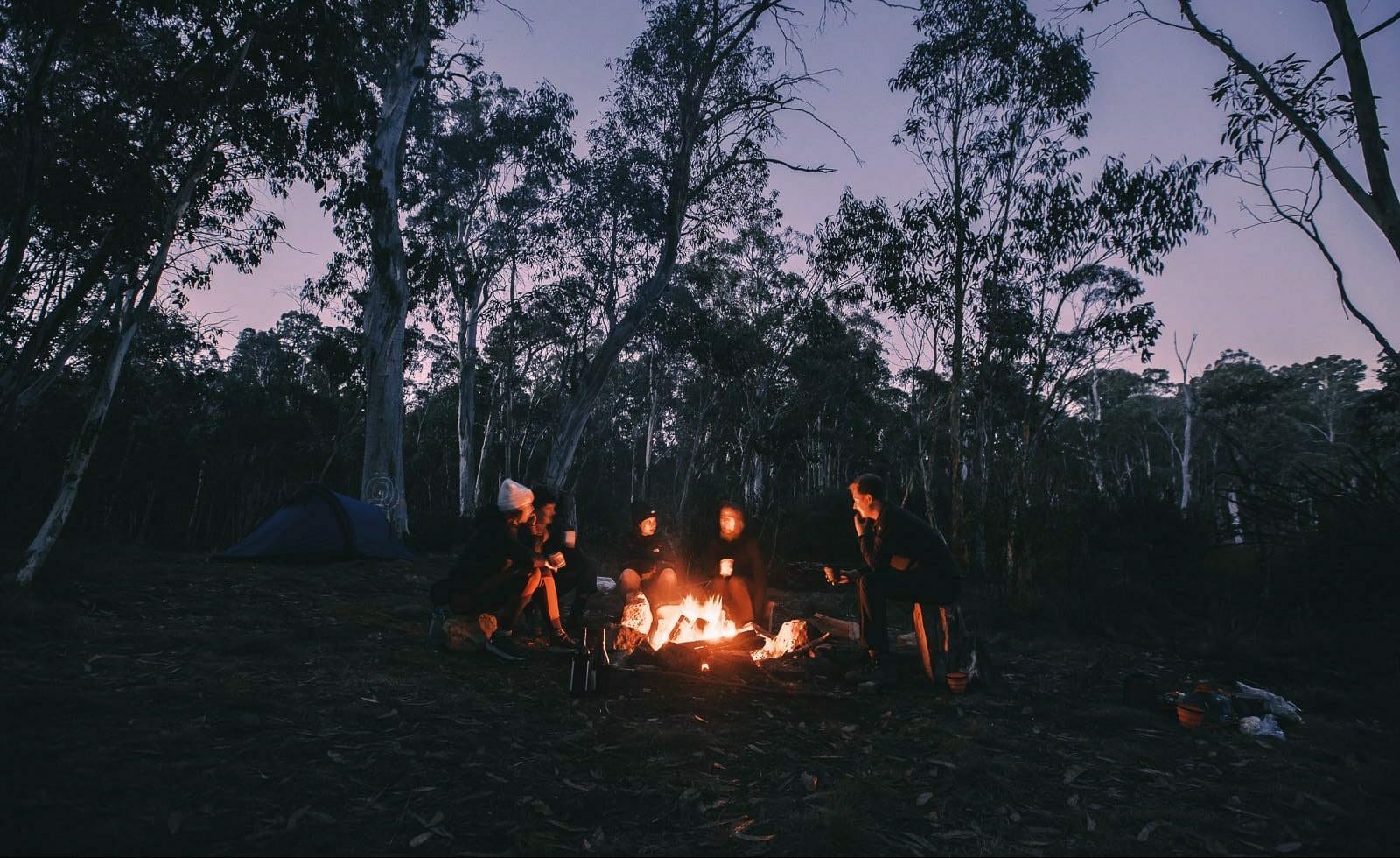 A group of people standing around a fire