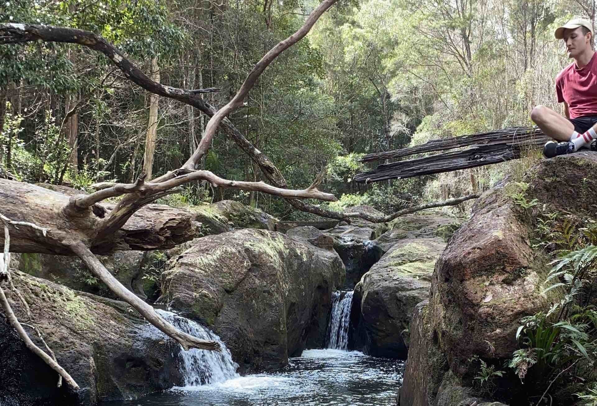 5 Hikes Hidden in the Byron Bay Hinterland, Jordan Clayden-Lewis, blue fig trail, waterfall, river, man