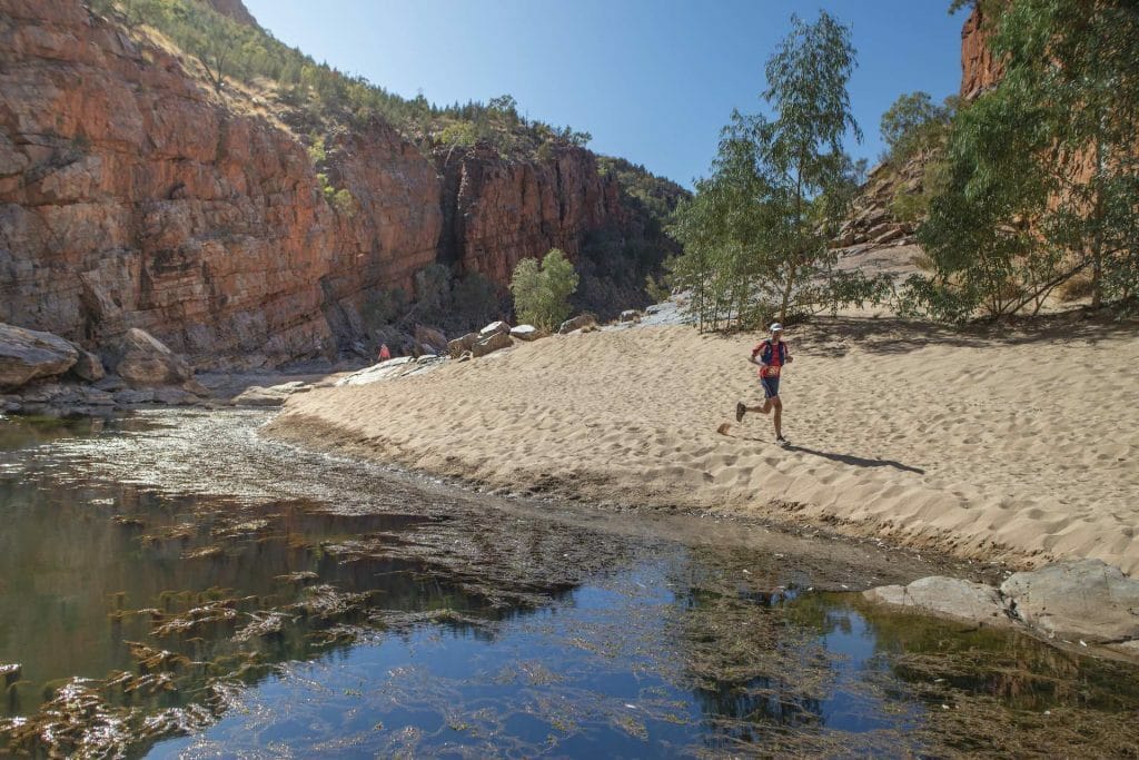 A man standing next to a body of water