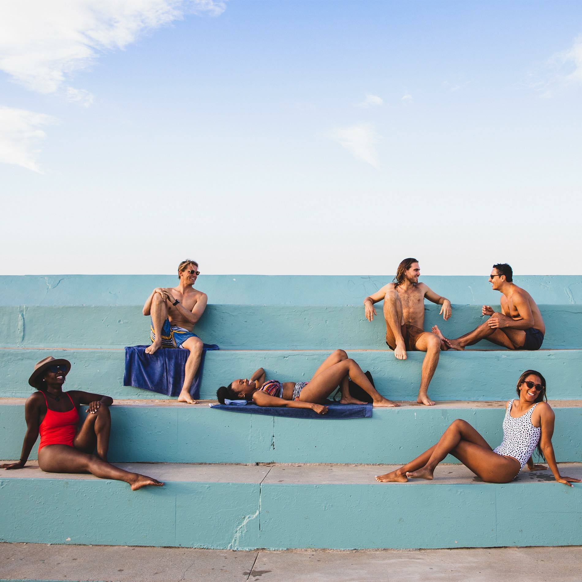 A group of people sitting at a beach