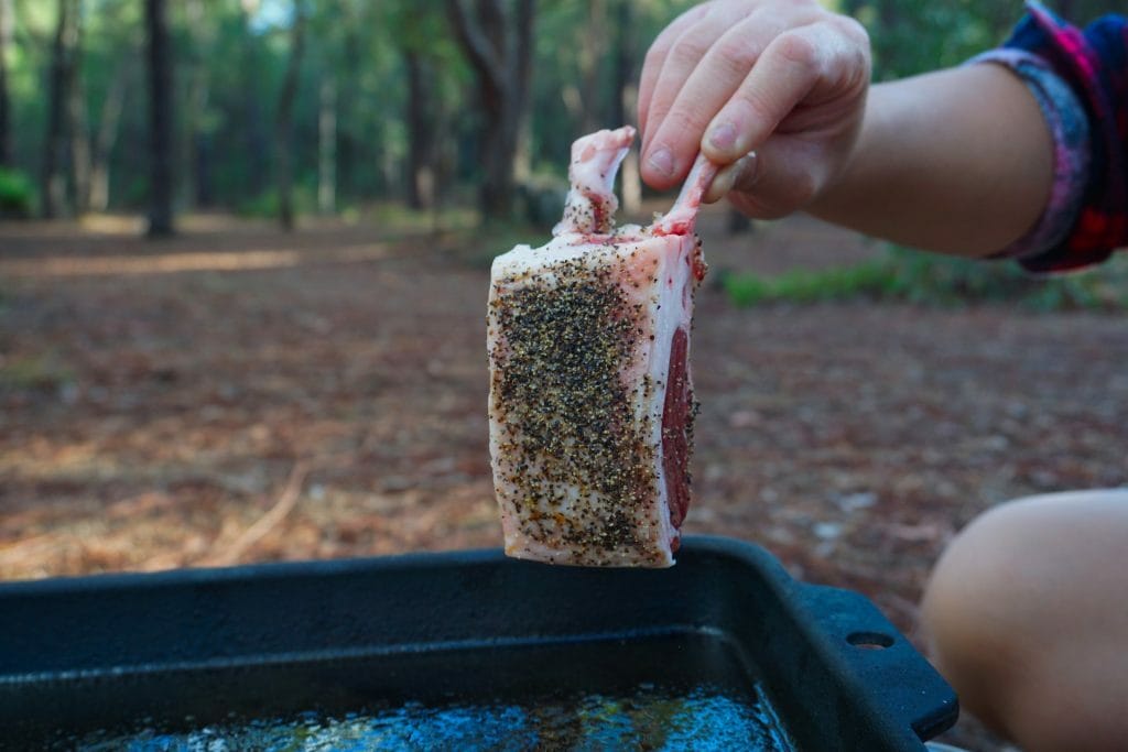 How To Cook The Ultimate Campfire Roast, Photo by Vanessa Hidayat, recipe, camping recipe, camp food, outdoor food, lamb rack seasoned with salt and pepper