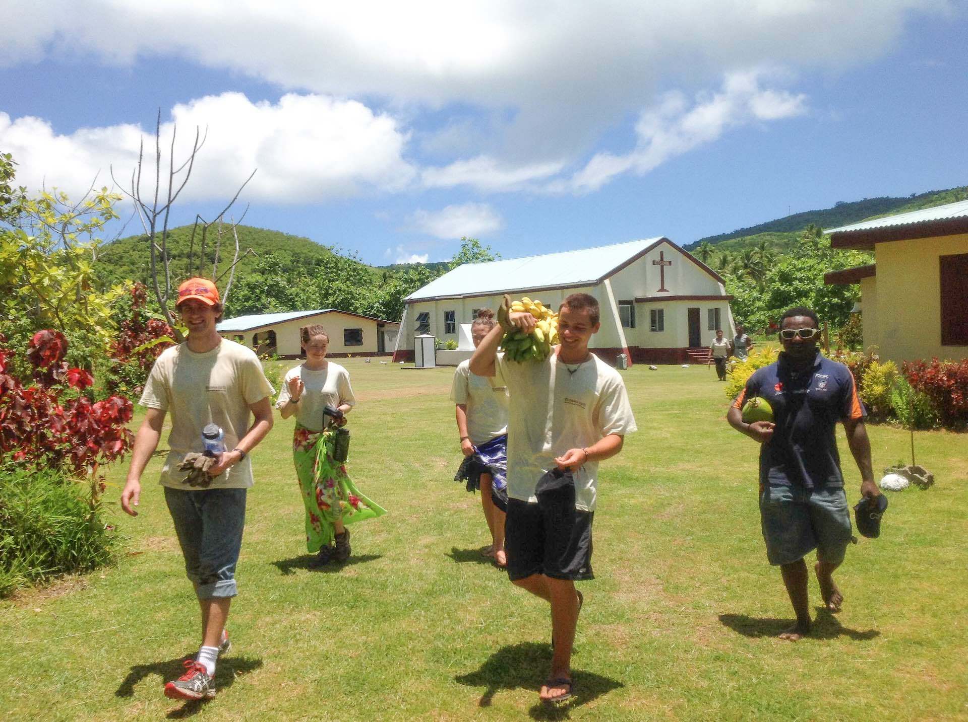 7 Awe-inspiring Experiences in Fiji’s Yasawa Islands, photo credit Vinaka Fiji, mountains, houses, friends, smile laugh