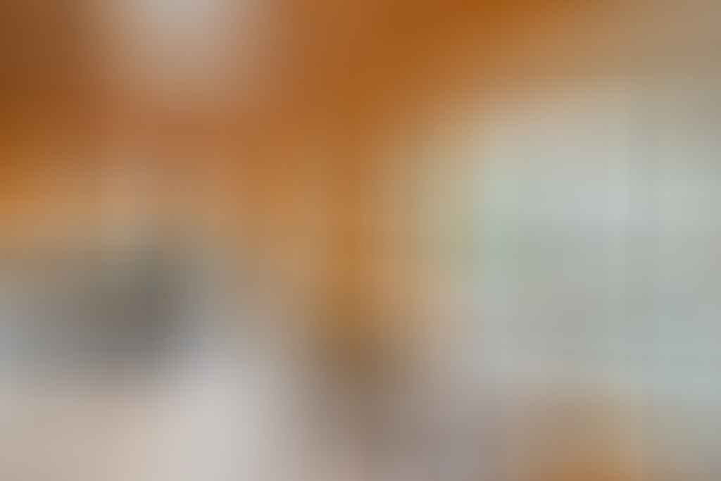 A dining room table in front of a window